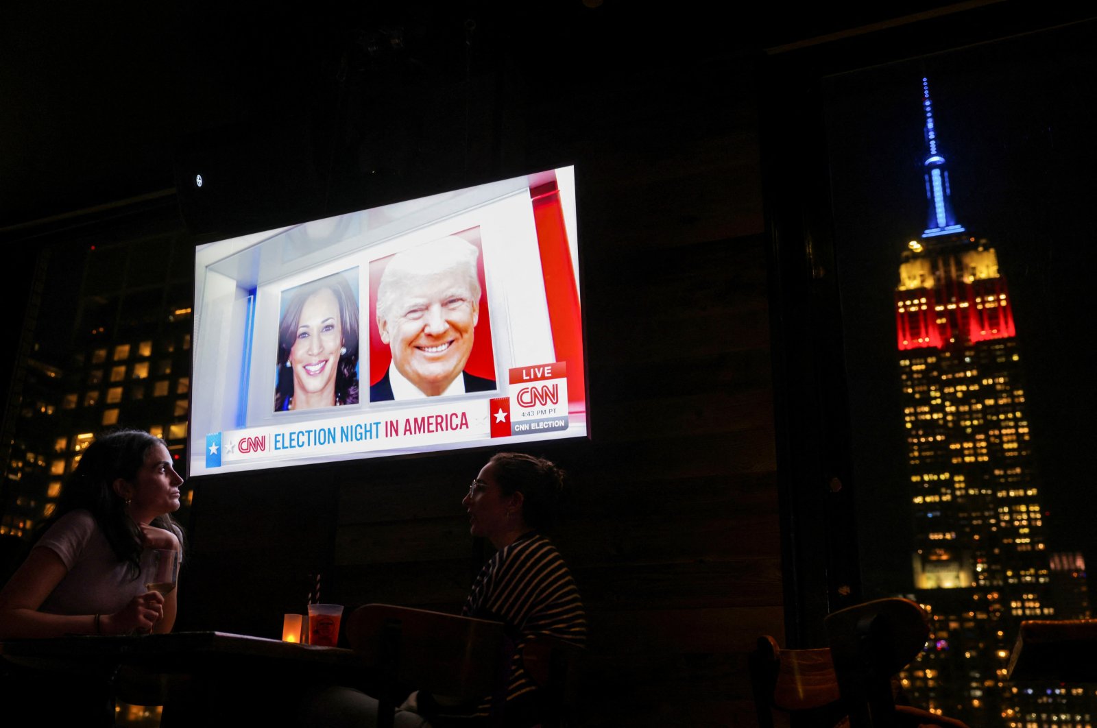 People attend a watch party at 230 Fifth Rooftop Bar, as the Empire State Building is seen in the background, New York City, U.S., Nov. 5, 2024. (Reuters Photo)