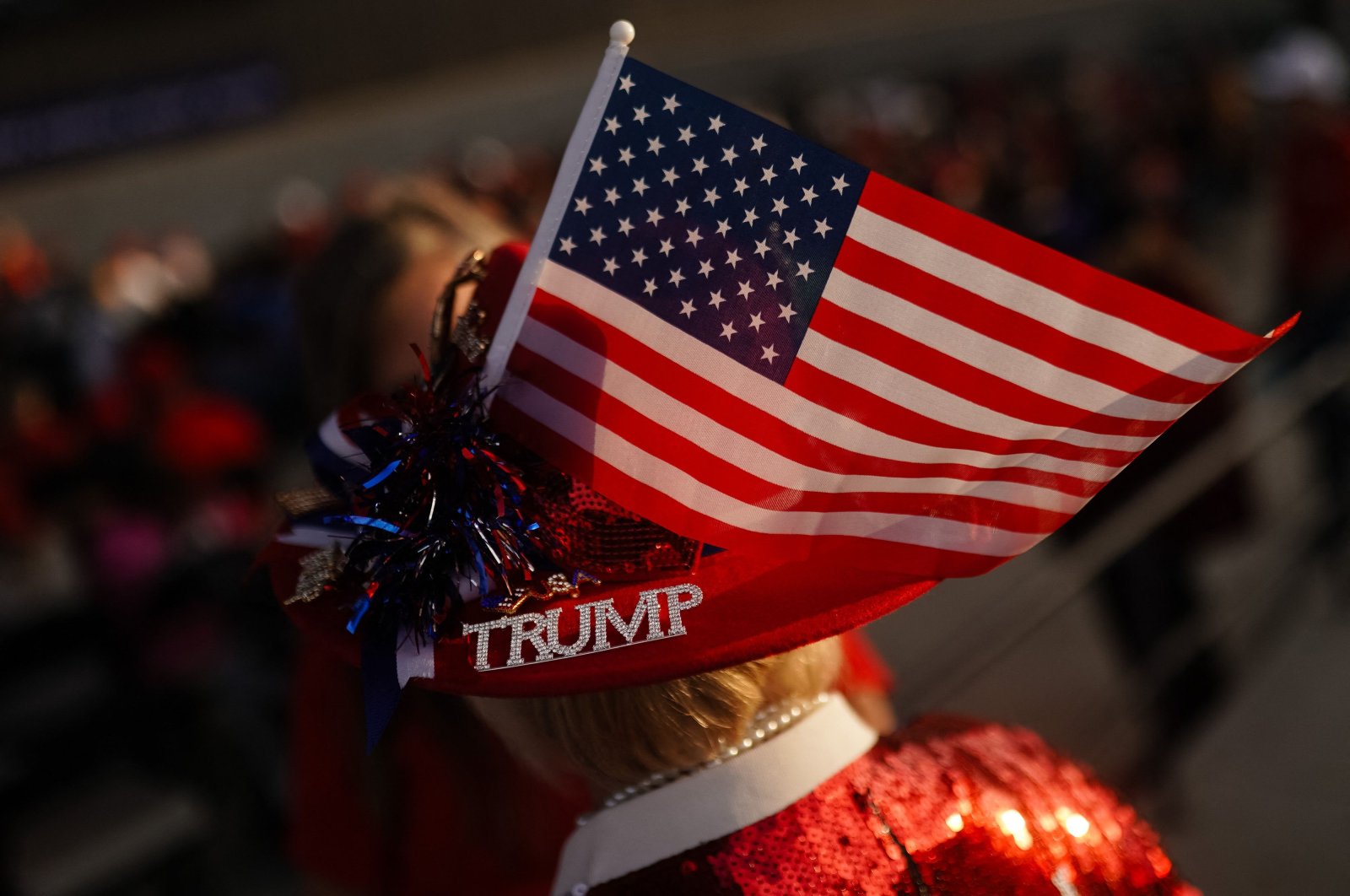 A supporter wears a hat with an American flag and a bejeweled &quot;Trump&quot; pin during a campaign rally for former U.S. President and Republican presidential candidate Donald Trump in Macon, Georgia, U.S., Nov. 3, 2024. (AFP Photo)