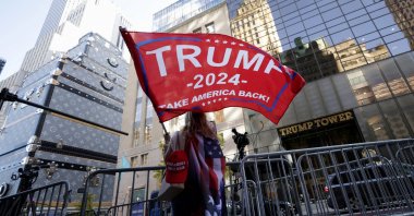 A person waves a Trump flag outside Trump Tower in New York City, U.S., Nov. 6, 2024. (Reuters Photo)