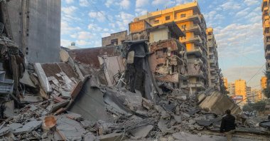 A man takes photos with his phone of the destruction at the site of an Israeli airstrike in the southern suburbs of Beirut, Lebanon, Nov. 7, 2024. (AFP Photo)