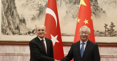Treasury and Finance Minister Mehmet Şimşek (L) shakes hands with Chinese Vice Premier Zhang Guoqing, Beijing, China, Nov. 7, 2024. (AA Photo)