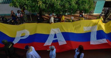 A Colombian flag with the word &quot;PEACE&quot; is seen during the military parade to commemorate Colombia&#039;s Independence Day in Tibu, North Santander Department, Colombia, July 20, 2024. (AFP File Photo)