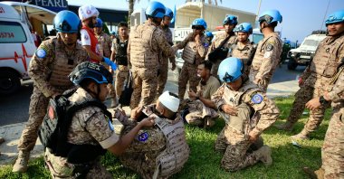 An injured member of the Malaysian UNIFIL peacekeeping force receives medical treatment at the site of an Israeli strike on a vehicle, at the entrance of the southern city of Sidon, Lebanon, Nov. 7, 2024. (EPA Photo)