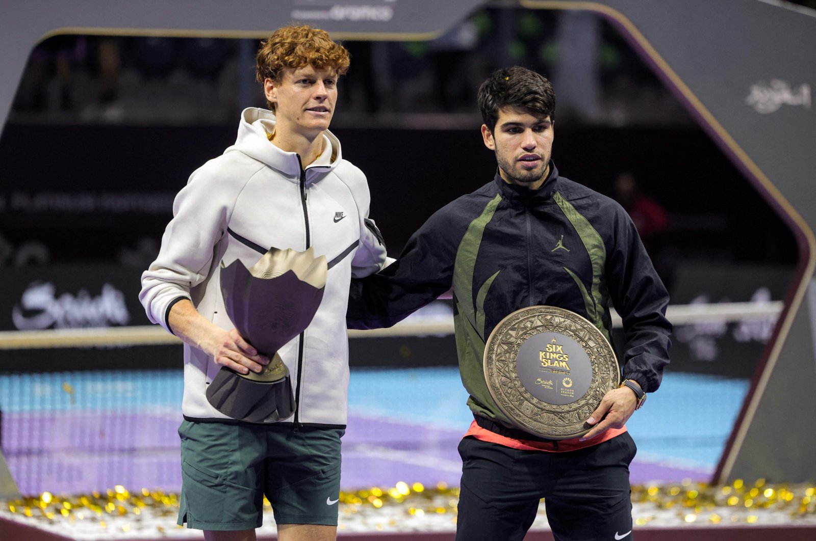 Italy&#039;s Jannik Sinner (L) poses with the winner&#039;s trophy next to Spain&#039;s Carlos Alcaraz during the awards ceremony after their final tennis match in the "6 Kings Slam" exhibition tournament, Riyadh, Suadi Arabia, Oct. 19, 2024. (AFP Photo)