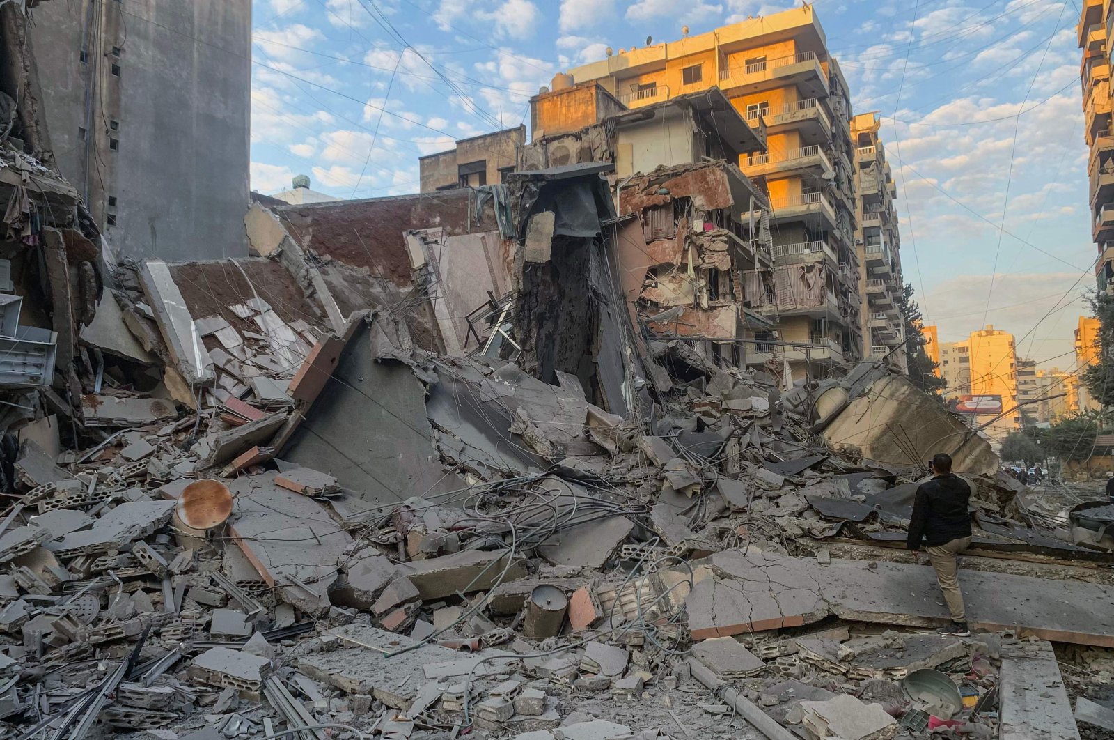 A man takes photos with his phone of the destruction at the site of an Israeli airstrike in the southern suburbs of Beirut, Lebanon, Nov. 7, 2024. (AFP Photo)