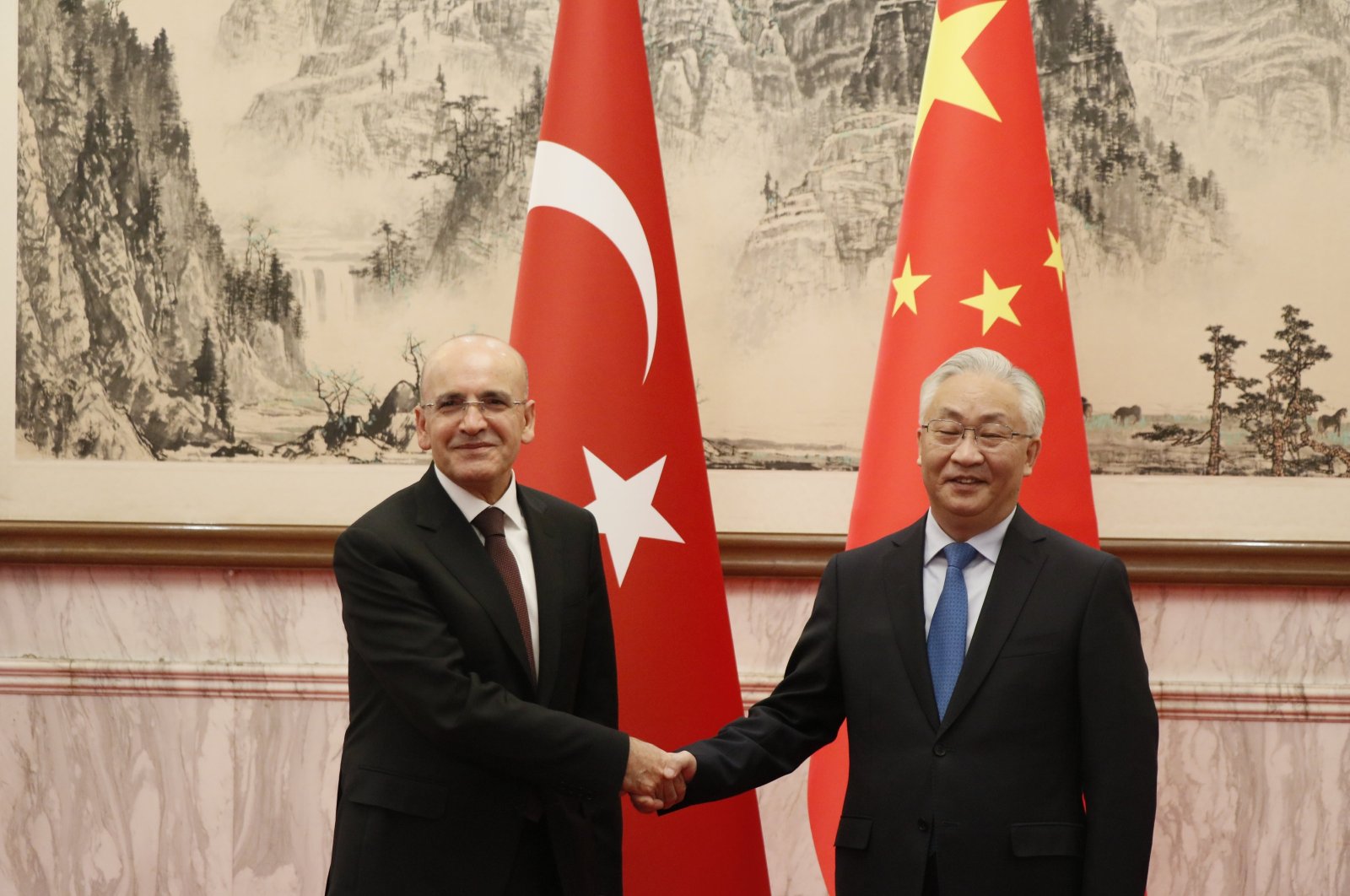 Treasury and Finance Minister Mehmet Şimşek (L) shakes hands with Chinese Vice Premier Zhang Guoqing, Beijing, China, Nov. 7, 2024. (AA Photo)