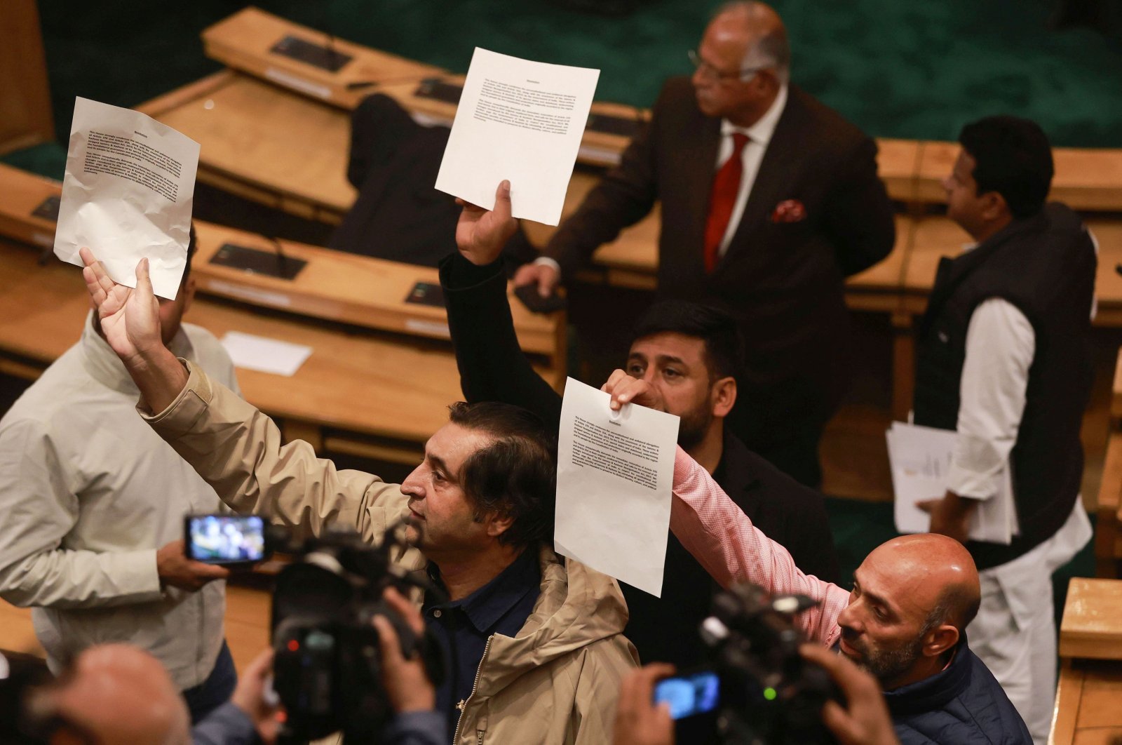 Legislators hold papers calling for bringing amendments in the resolution on the restoration of the special status of Jammu and Kashmir, in Srinagar, Kashmir, India, Nov. 7, 2024. (EPA Photo)