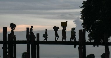 People walk on U Bein bridge at Taungthaman Lake, Mandalay, Myanmar, Oct. 23, 2024. (AFP Photo)