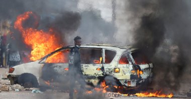 A protester looks on near a burning barricade during a "national shutdown" against the election outcome, Maputo, Mozambique, Nov. 7, 2024. (Reuters Photo)