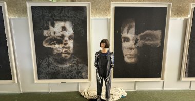 An undated handout photo made available by Sotheby's shows the Ai-Da Robot in front of their AI-created 'A.I. God.' Portrait of Alan Turing's artwork, at the United Nations in Geneva, Switzerland, Nov. 1, 2024. (EPA Photo)