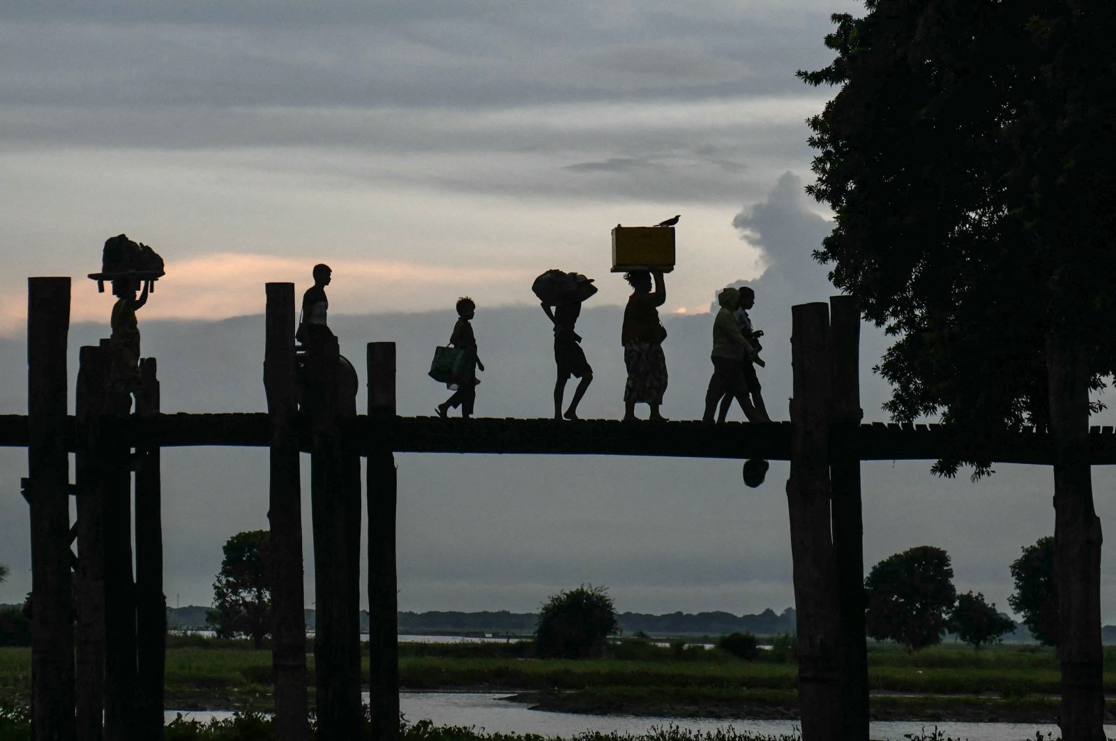 People walk on U Bein bridge at Taungthaman Lake, Mandalay, Myanmar, Oct. 23, 2024. (AFP Photo)