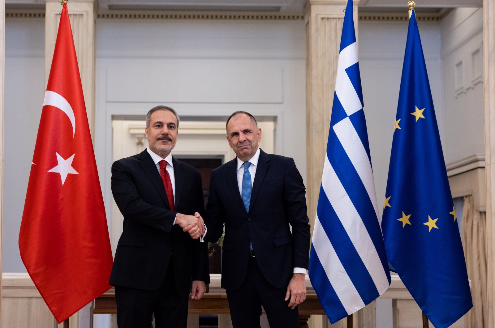 Greek Foreign Minister Giorgos Gerapetritis (R) shakes hands with Turkish Foreign Minister Hakan Fidan (L) prior to their talks, Athens, Greece, Nov. 8, 2024. (AA Photo)