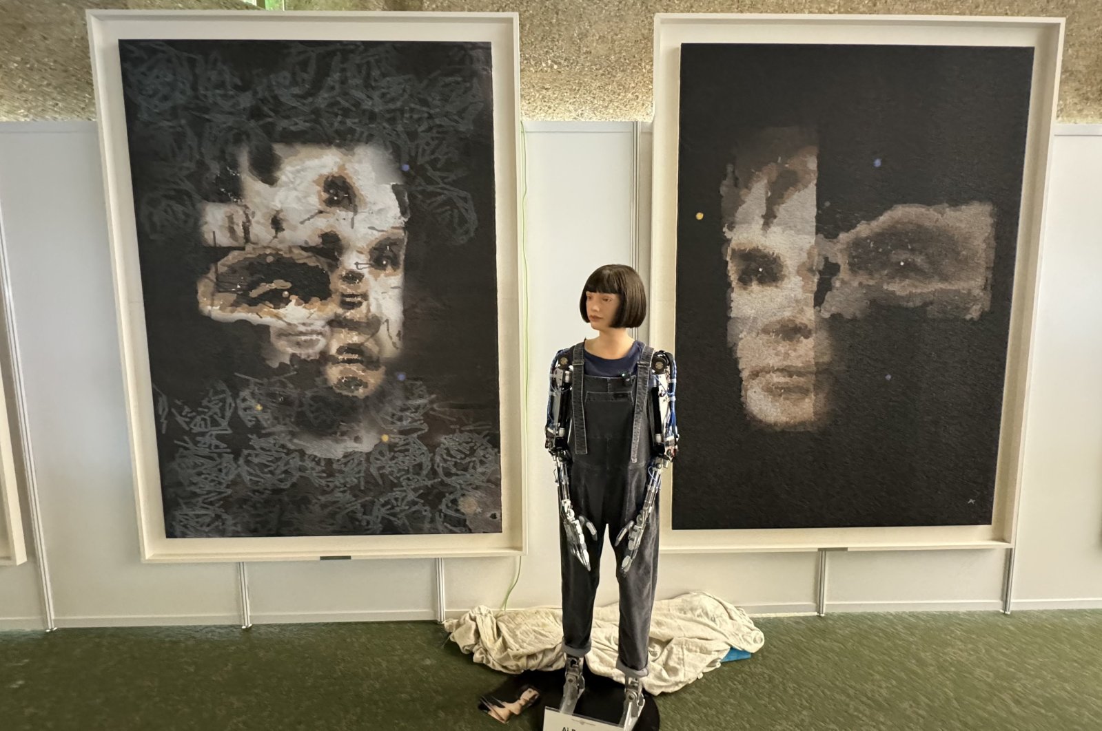 An undated handout photo made available by Sotheby&#039;s shows the Ai-Da Robot in front of their AI-created &#039;A.I. God.&#039; Portrait of Alan Turing&#039;s artwork, at the United Nations in Geneva, Switzerland, Nov. 1, 2024. (EPA Photo)