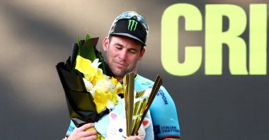 Astana Qazaqstan Team&#039;s Mark Cavendish celebrates with the trophy on the podium after winning the race Tour de France Singapore Criterium sprint, Singapore, Nov. 10, 2024. (Reuters Photo)