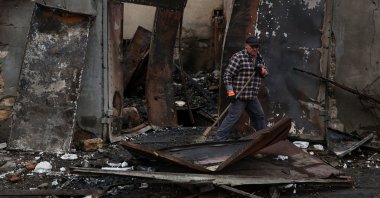 A resident removes debris from a garage heavily damaged by a Russian drone strike, Odesa, Ukraine, Nov. 10, 2024. (Reuters Photo)
