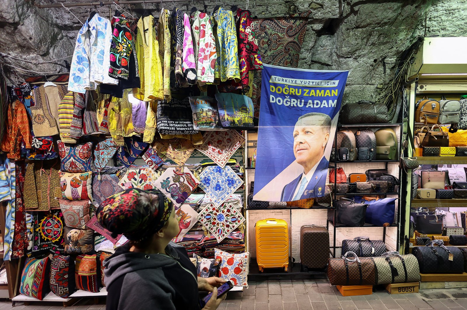 A person walks near a flag featuring an image of President Tayyip Erdoğan, after he won the second round of the presidential election, at the Grand Bazaar, Istanbul, Türkiye, May 29, 2023. (Reuters Photo)