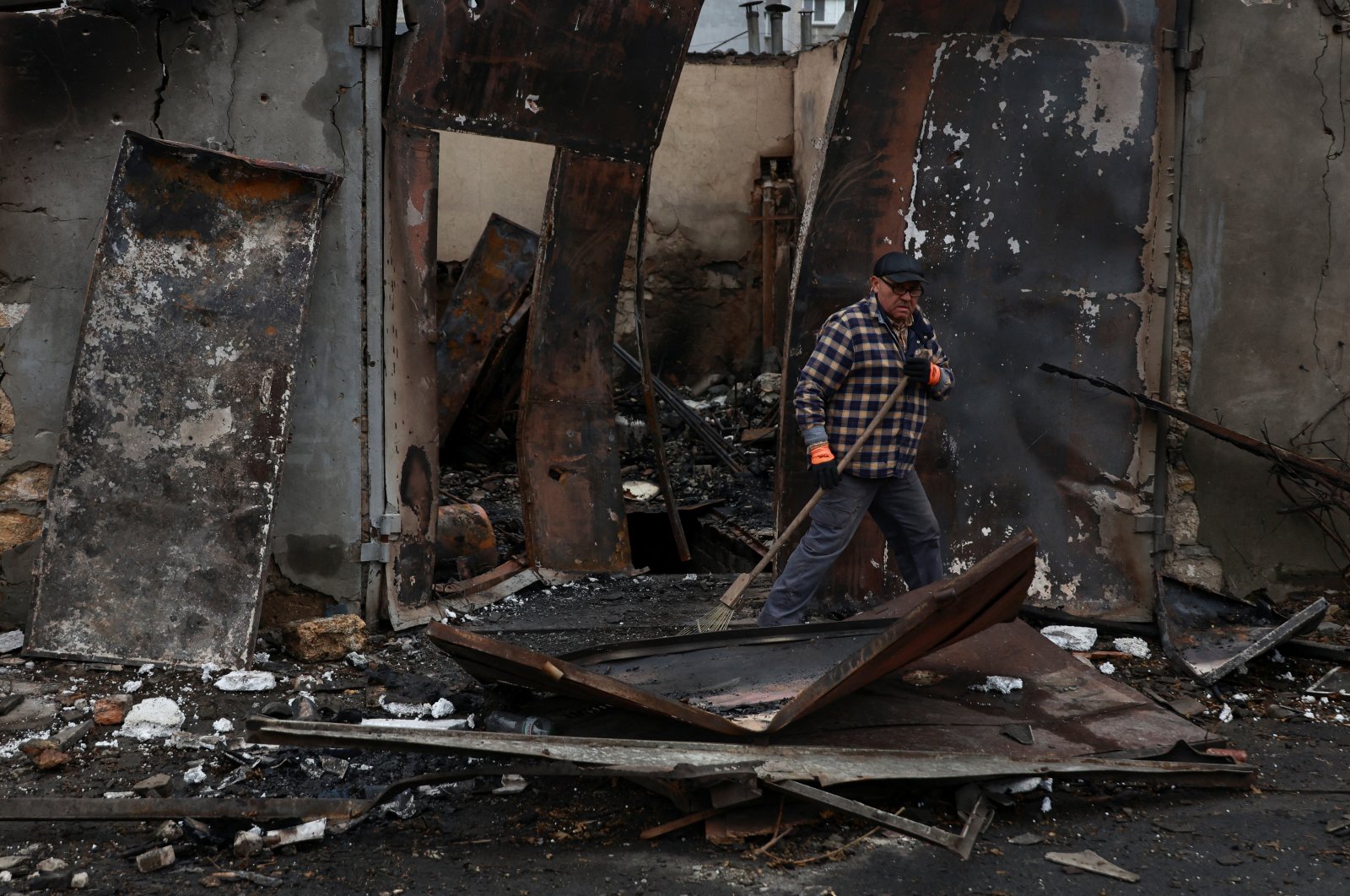 A resident removes debris from a garage heavily damaged by a Russian drone strike, Odesa, Ukraine, Nov. 10, 2024. (Reuters Photo)