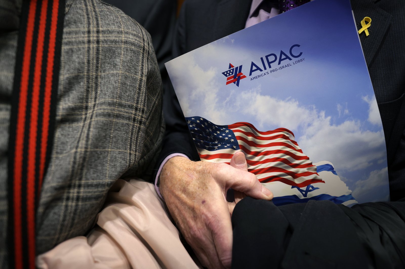 A visitor holds an AIPAC folder on Capitol Hill in Washington, D.C., U.S., March 12, 2024. (Getty Images)