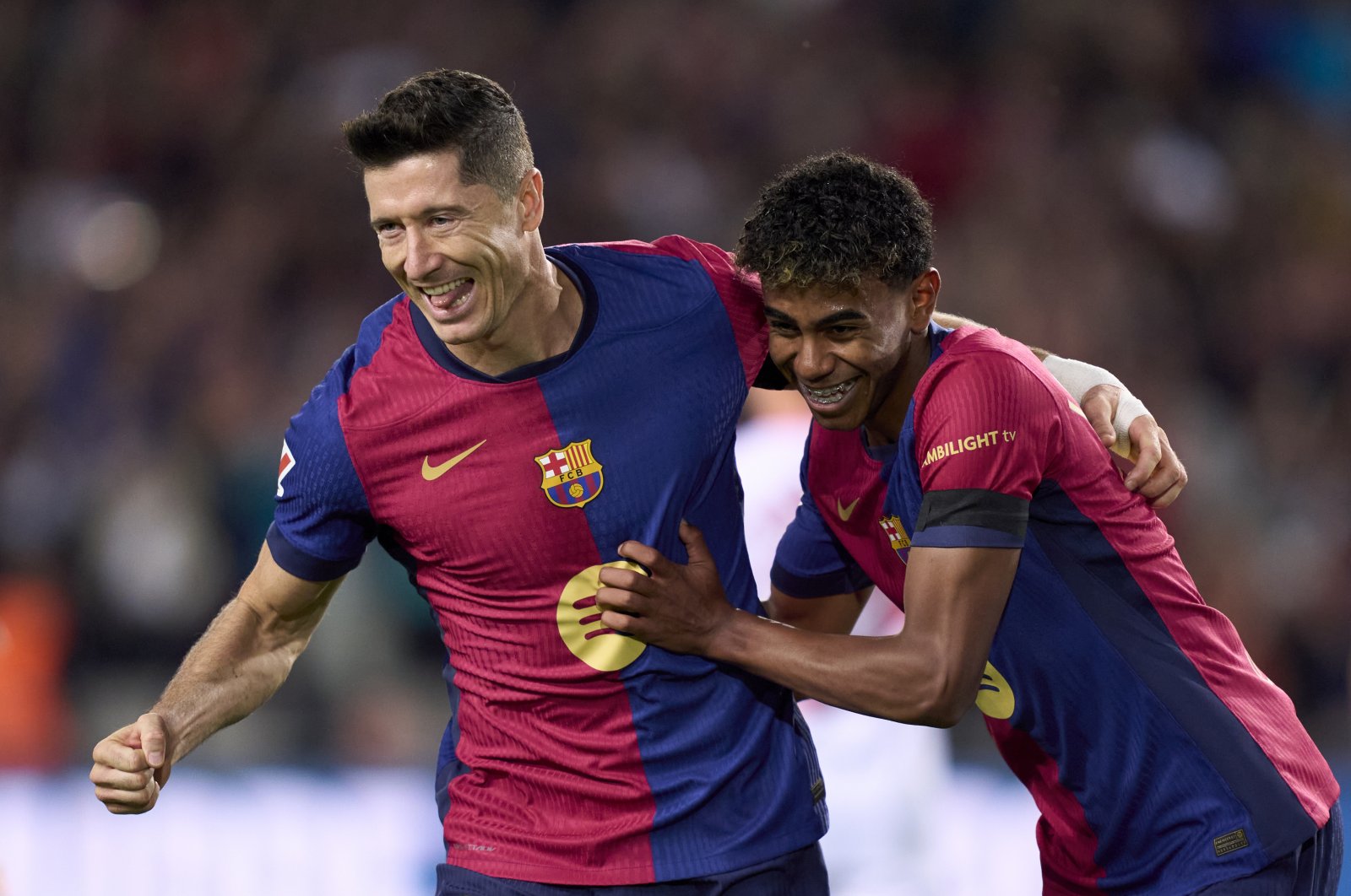 Barcelona&#039;s Robert Lewandowski (L) celebrates with his teammate Lamine Yamal after scoring his team&#039;s first goal during the La Liga match against Sevilla at Estadi Olimpic Lluis Companys, Barcelona, Spain, Oct. 20, 2024. (Getty Images Photo)