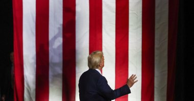 Republican presidential nominee and former U.S. President Donald Trump stands facing an American flag on the day he delivers remarks in Allentown, Pennsylvania, U.S., Oct. 29, 2024. (Reuters Photo)