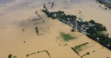An aerial photo shows a swollen river inundating farm fields and houses at a village in Ilagan town, a day after Typhoon Toraji hit the Isabela province, the Philippines, Nov. 12, 2024. (AFP Photo)