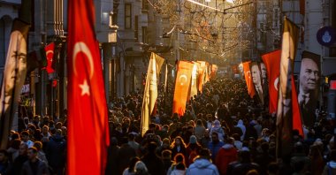 People walk on Istiklal Street in Istanbul, decorated with Turkish and Atatürk flags to mark the 86th anniversary of the death of Mustafa Kemal Atatürk, the founder of the modern Turkish republic, Istanbul, Türkiye, Nov. 10, 2024. (AFP Photo)