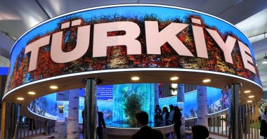 People walk near Türkiye&#039;s pavilion in the Green Zone at the COP29 United Nations Climate Change Conference in Baku, Azerbaijan. Nov. 11, 2024. (Reuters Photo) 