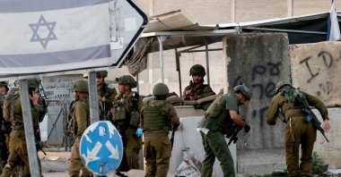 Israeli soldiers search the body of a Palestinian man after an incident near the Palestinian village of Deir Sharaf, near the West Bank city of Nablus, Palestine, Nov. 12, 2024. (EPA Photo)