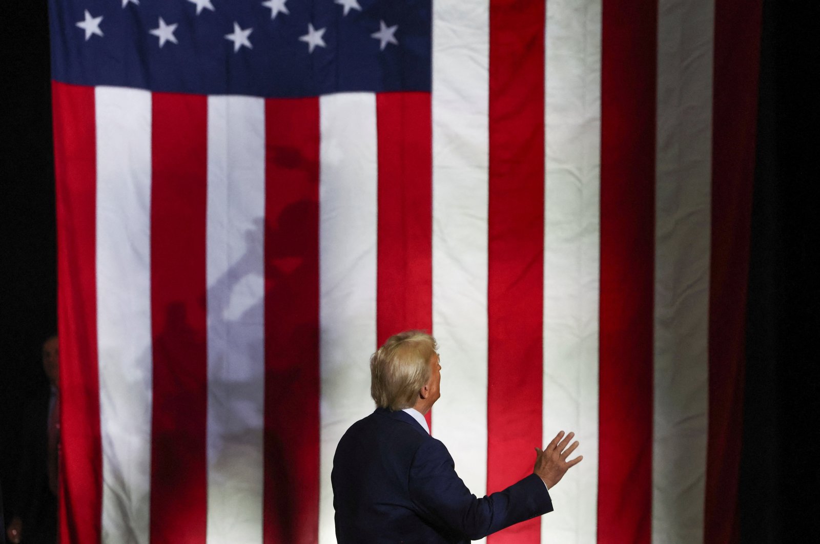 Republican presidential nominee and former U.S. President Donald Trump stands facing an American flag on the day he delivers remarks in Allentown, Pennsylvania, U.S., Oct. 29, 2024. (Reuters Photo)