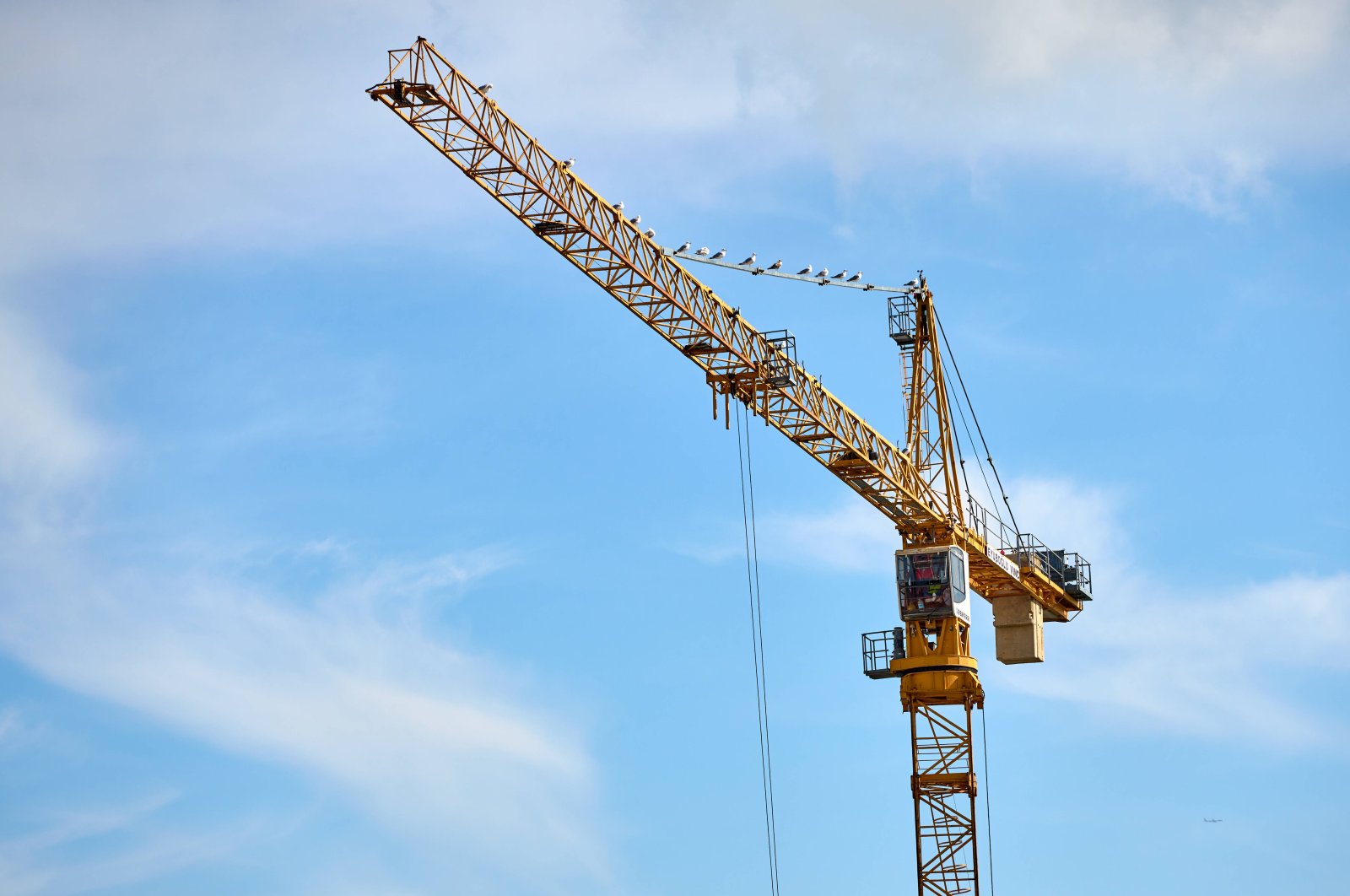 A yellow construction crane rises into the sky in Istanbul, Türkiye, Sept. 2, 2024. (Reuters Photo)