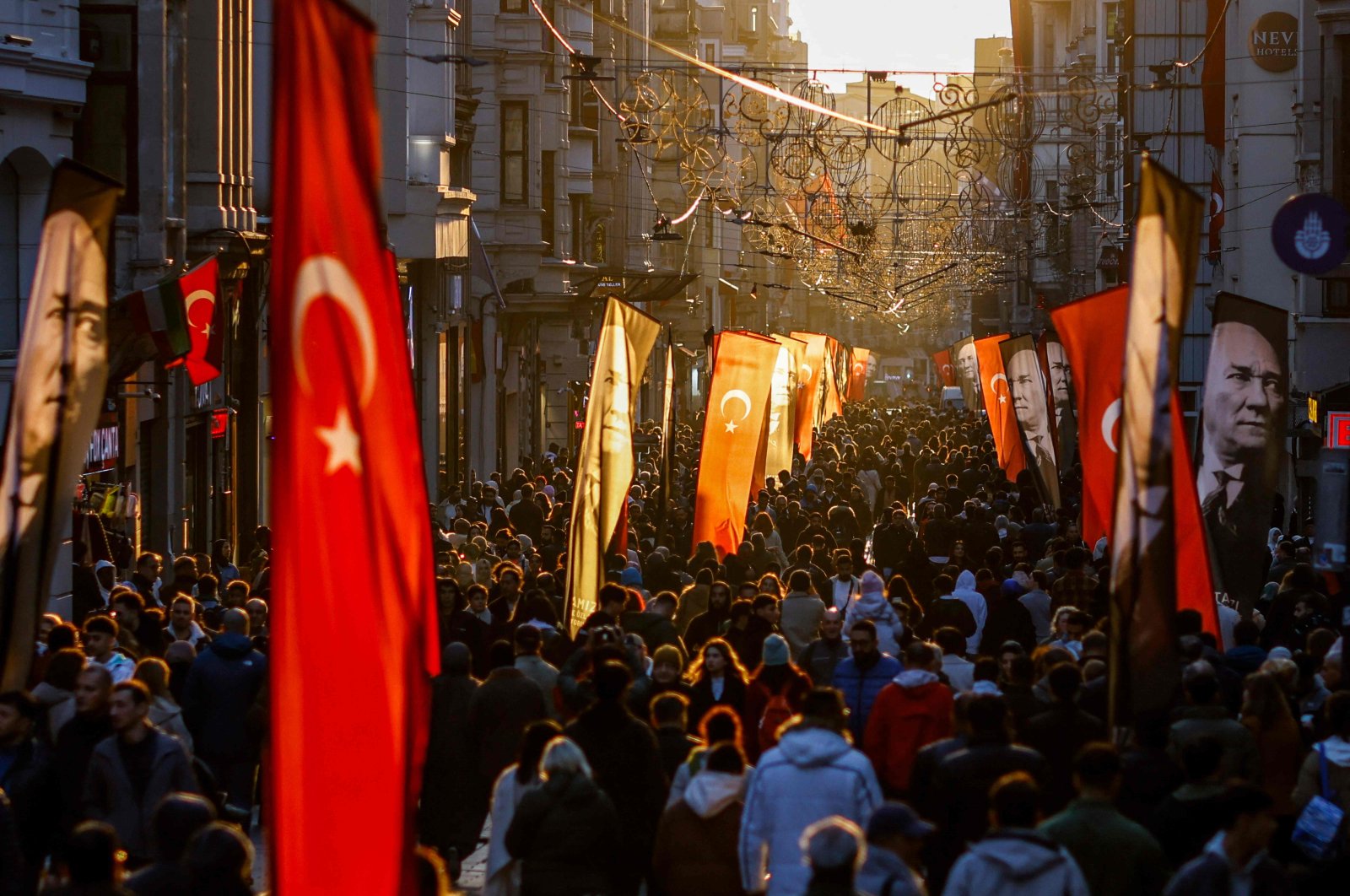 People walk on Istiklal Street in Istanbul, decorated with Turkish and Atatürk flags to mark the 86th anniversary of the death of Mustafa Kemal Atatürk, the founder of the modern Turkish republic, Istanbul, Türkiye, Nov. 10, 2024. (AFP Photo)