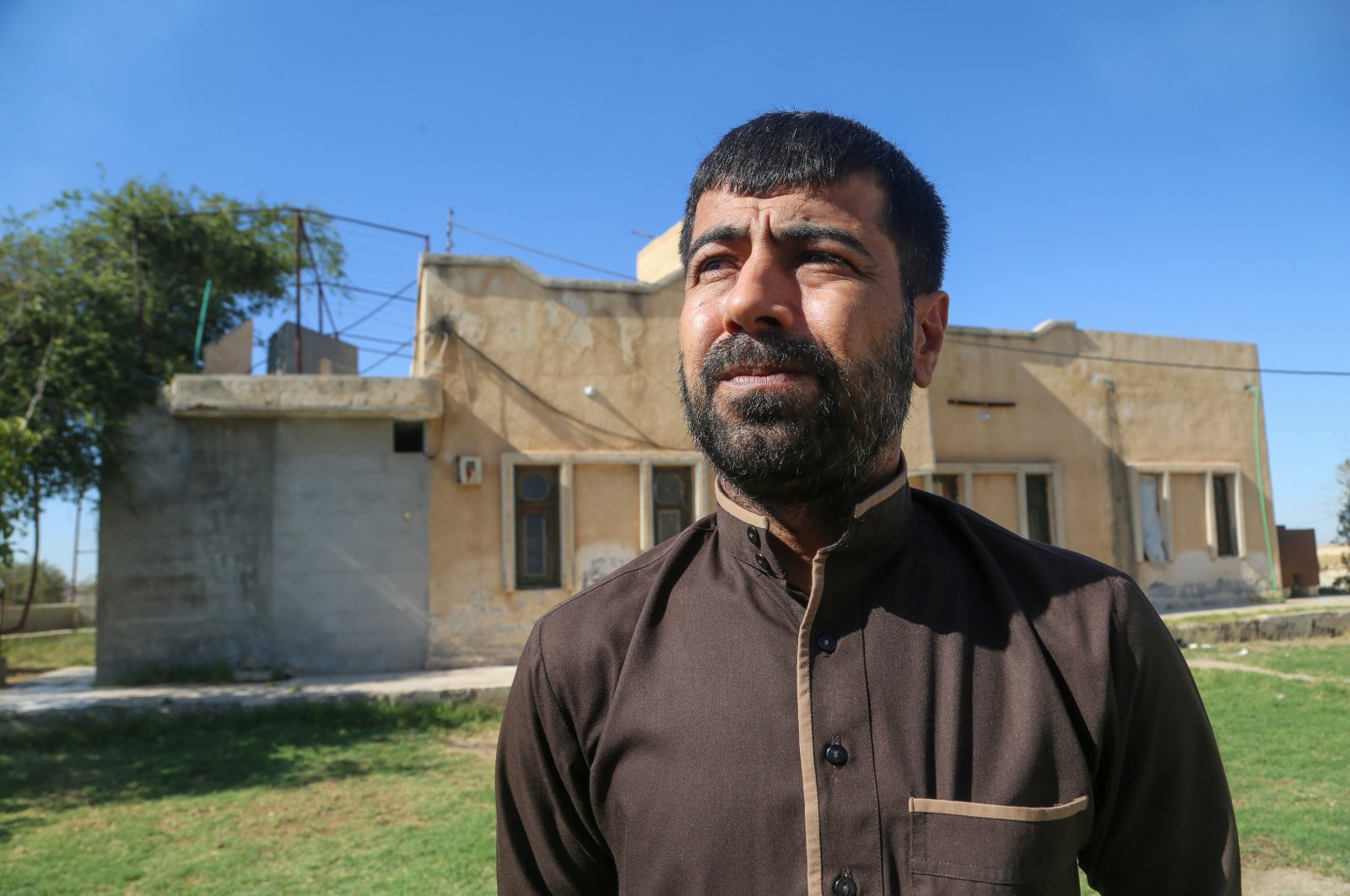 Uways Bathavi, who was detained for five years by PKK/YPG terrorists, speaks during an interview in the northern region of Tal Abyad, Syria, June 27, 2024. (AA Photo)