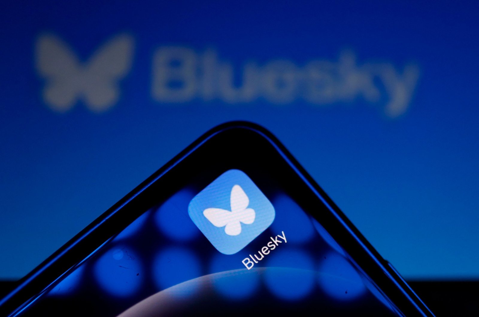 This illustration photograph shows the logo of the social media platform Bluesky displayed on a mobile telephone and tablet, Paris, France, Nov. 12, 2024. (AFP Photo)