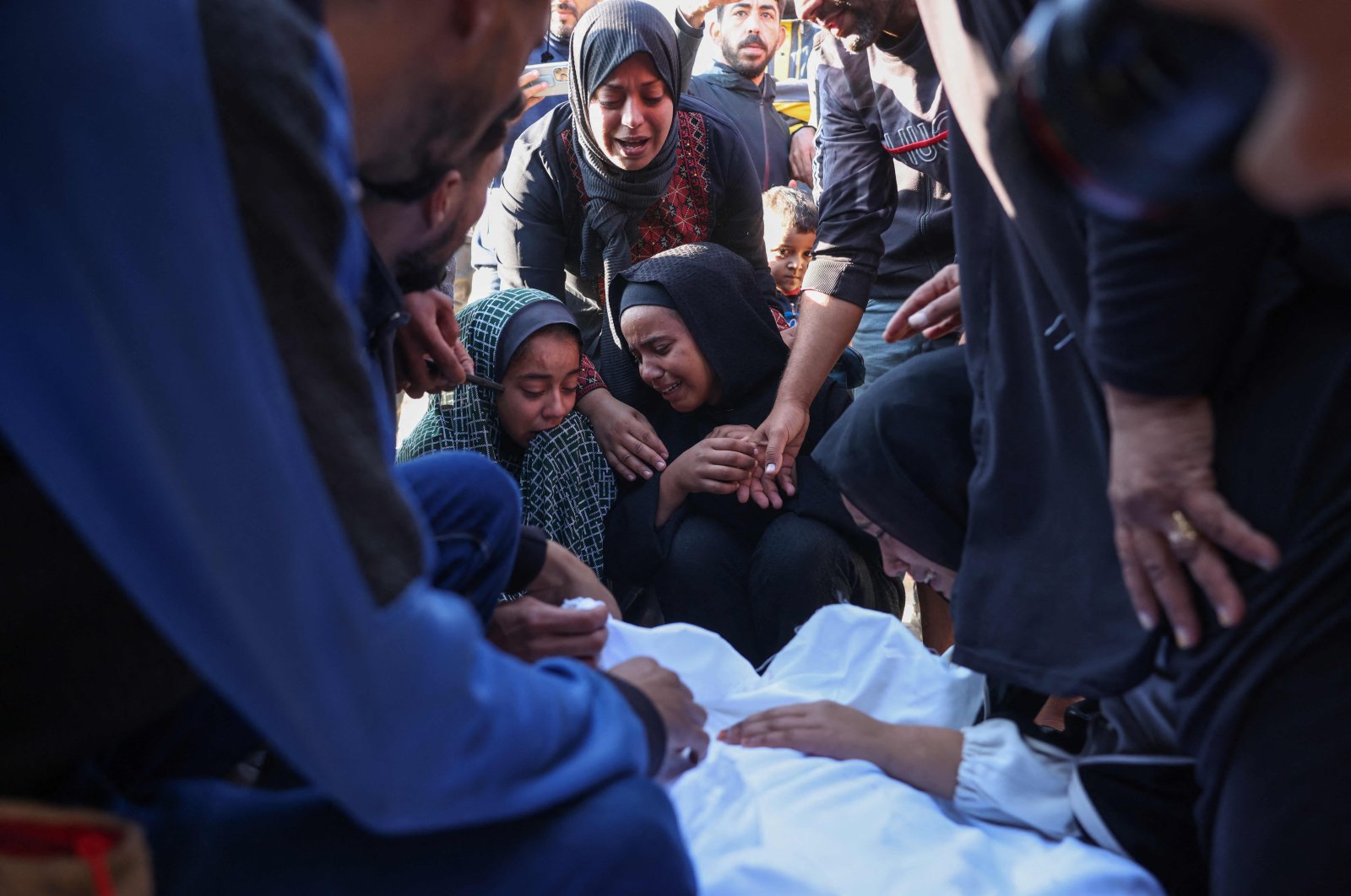 Palestinians mourn by the body of a relative killed in overnight Israeli strikes on the al-Mawasi cafeteria at Nasser hospital, Khan Younis, Gaza Strip, Palestine, Nov. 12, 2024. (AFP Photo)