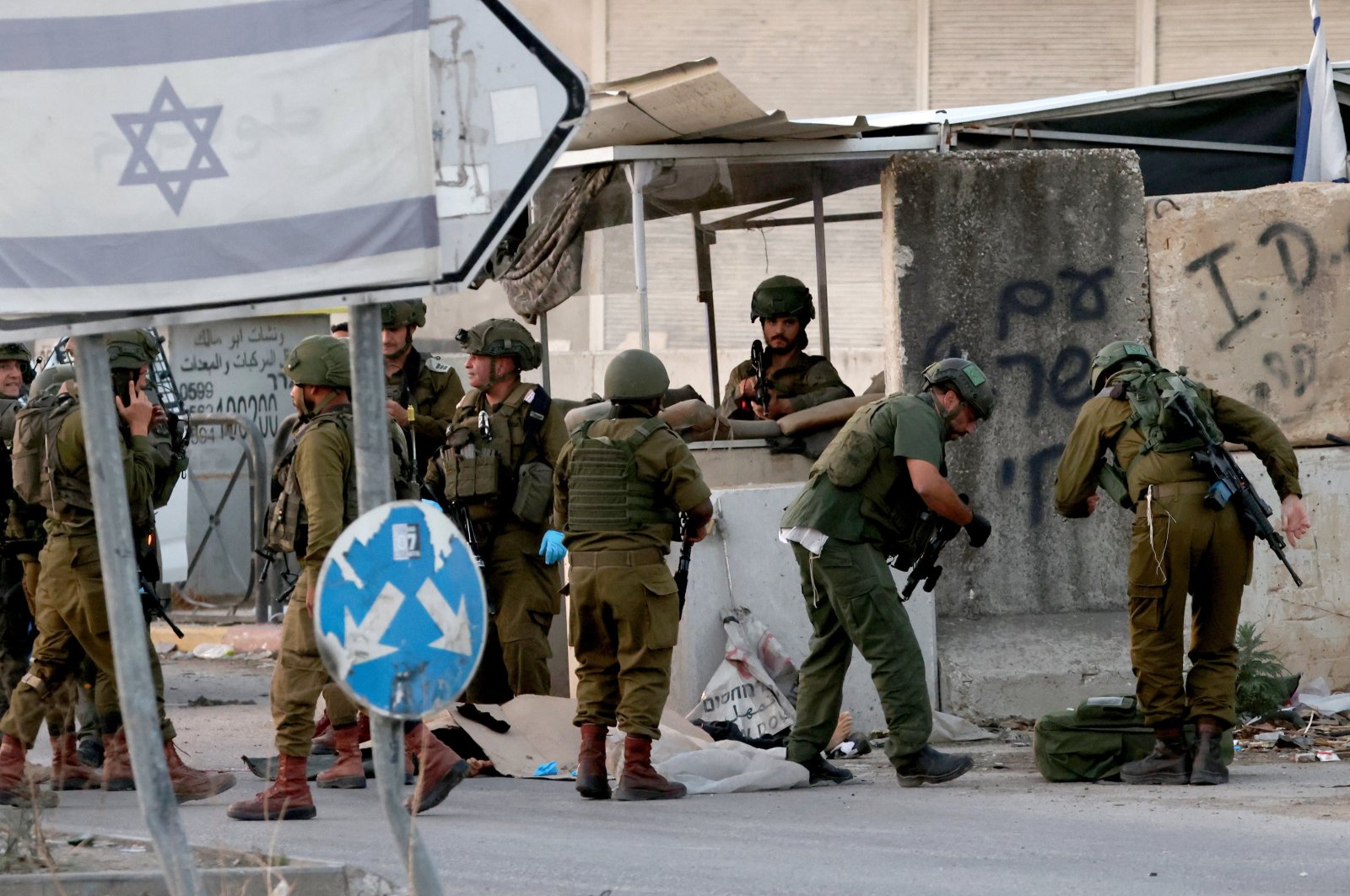 Israeli soldiers search the body of a Palestinian man after an incident near the Palestinian village of Deir Sharaf, near the West Bank city of Nablus, Palestine, Nov. 12, 2024. (EPA Photo)