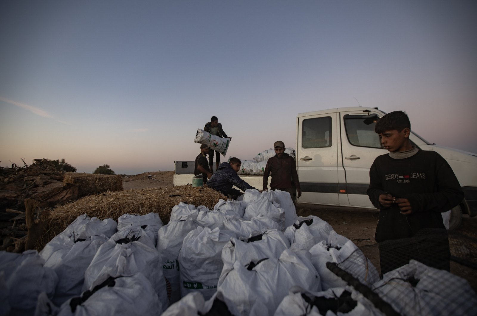 Gazans load a truck of completed charcoal at a charcoal production facility near displaced people&#039;s tents, Khan Yunis, Gaza Strip, Palestine, Oct. 30, 2024. (EPA Photo)