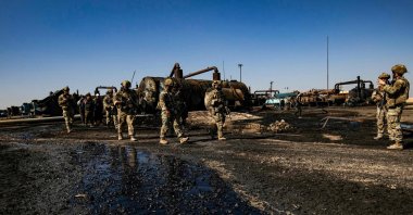 U.S. soldiers inspect the site of reported Turkish shelling on an oil extraction facility controlled by PKK/YPG terrorists on the outskirts of northeastern Rumaylan district, Hassakeh province, Syria, Oct. 28, 2024. (AFP Photo)