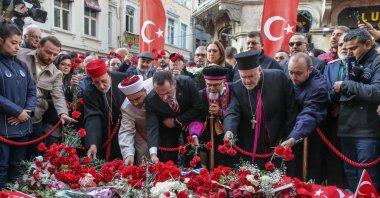 People leave flowers in memory of victims at the site of the Istiklal Street attack, Istanbul, Türkiye, Nov. 16, 2022. (AA Photo)