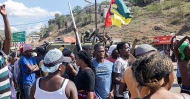 A military armoured vehicle blocks the road as protesters try to make their way to the Ressano Garcia border post between Mozambique and South Africa, Nov. 13, 2024. (AFP Photo)