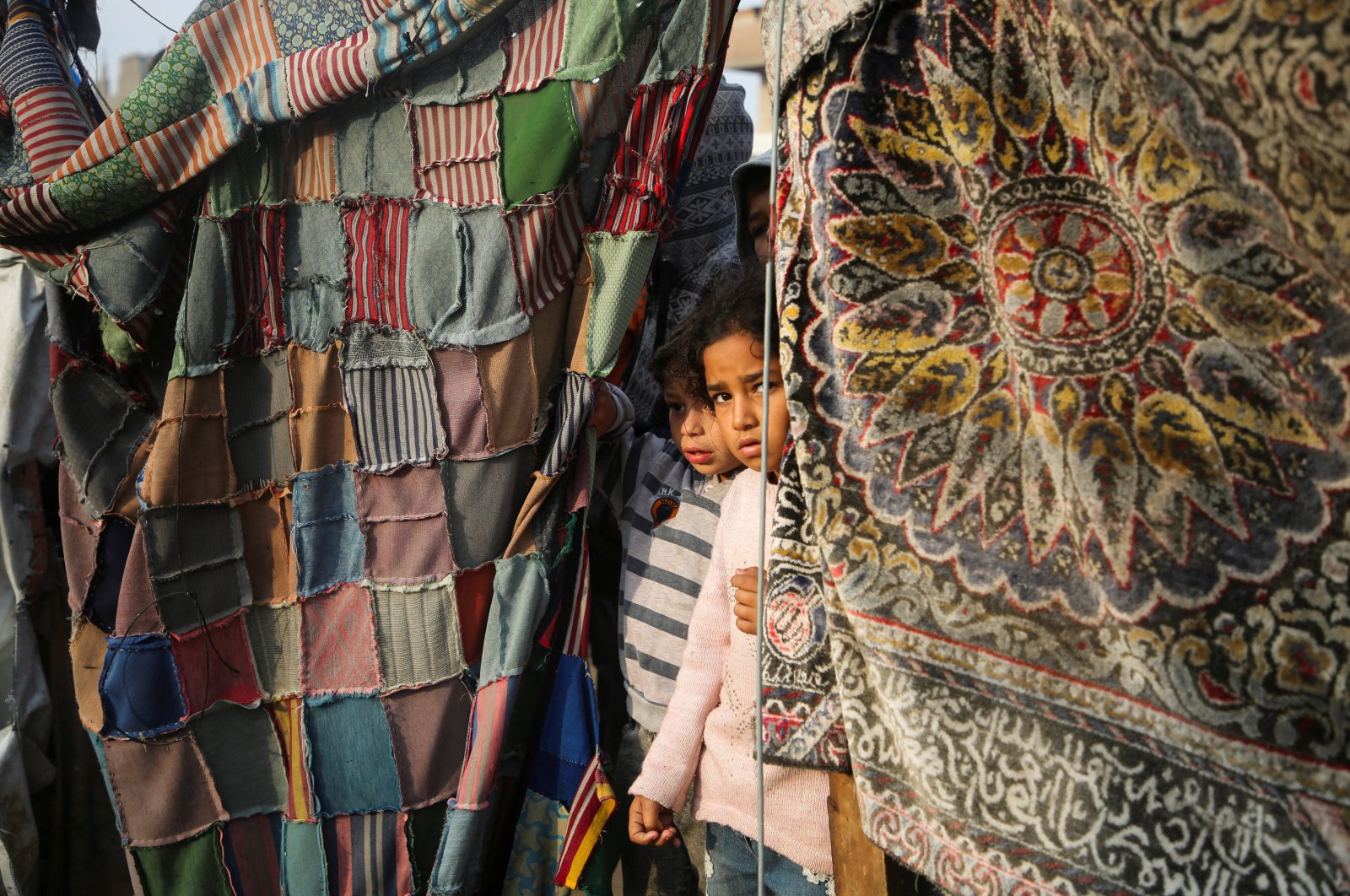 Palestinian children stand at the site of an Israeli strike on a tent housing displaced people in Khan Younis, southern Gaza Strip, Palestine, Nov. 9, 2024. (Reuters Photo)