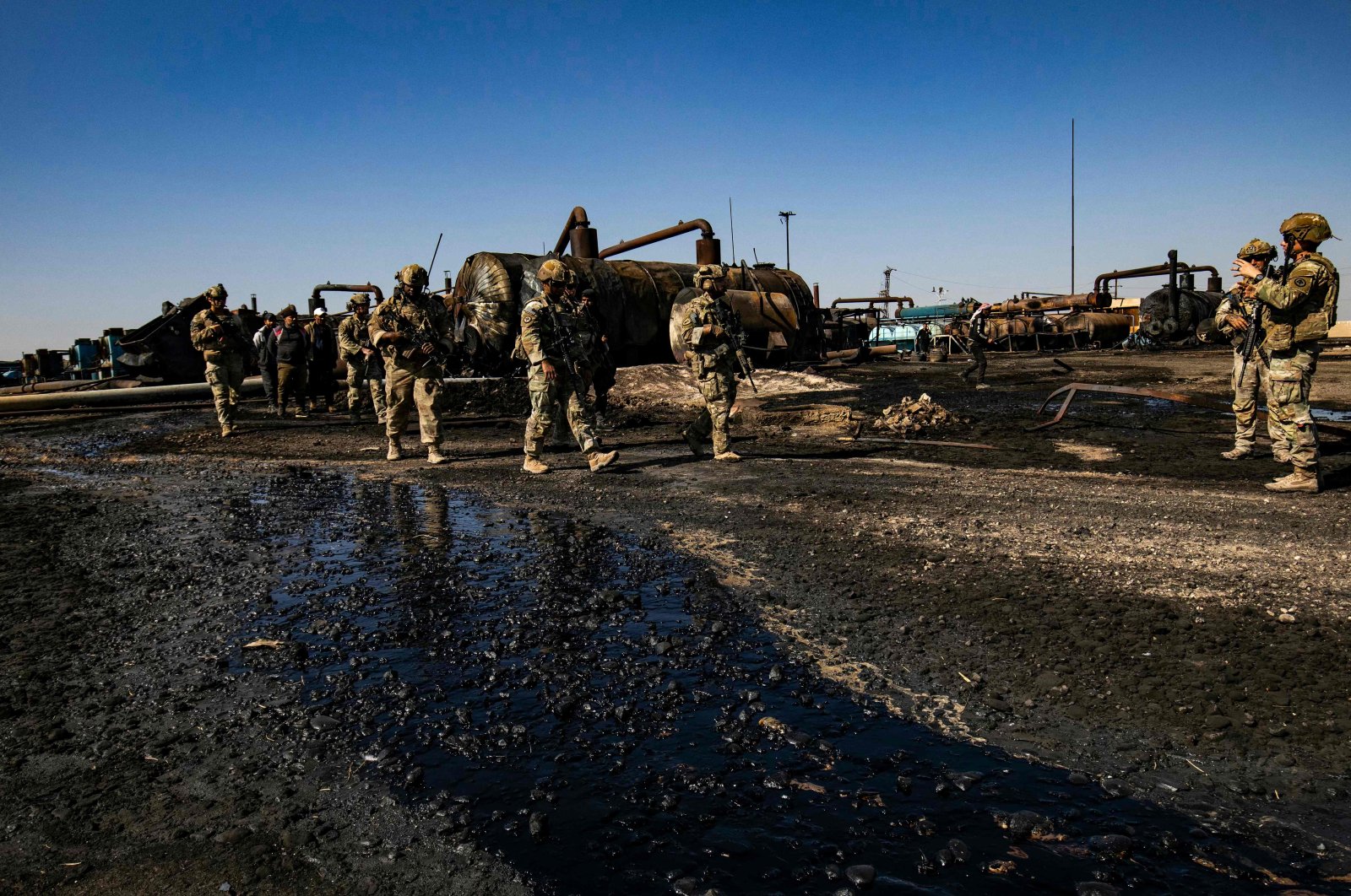 U.S. soldiers inspect the site of reported Turkish shelling on an oil extraction facility controlled by PKK/YPG terrorists on the outskirts of northeastern Rumaylan district, Hassakeh province, Syria, Oct. 28, 2024. (AFP Photo)