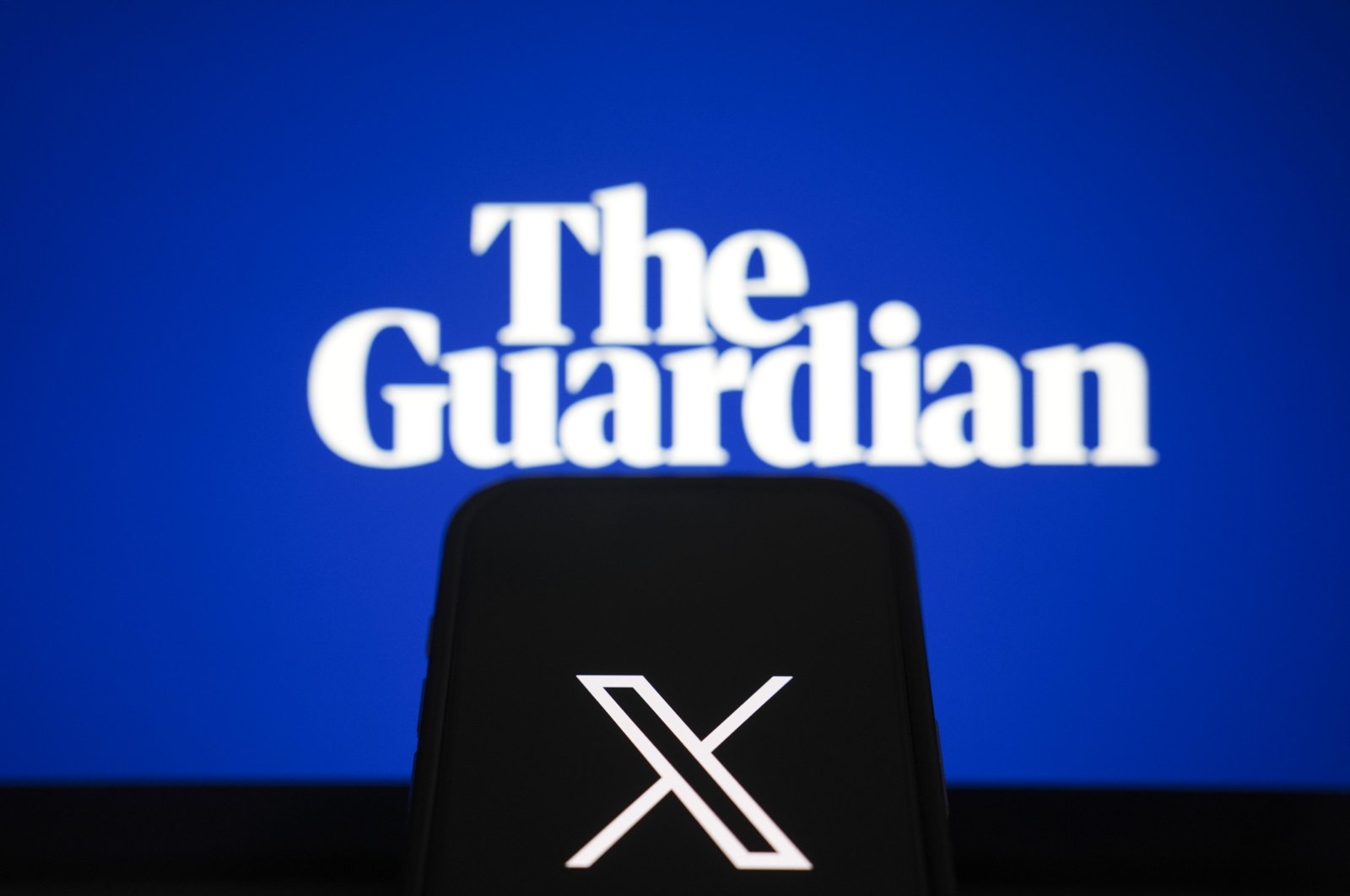 Logos of The Guardian and social media platform X are seen in this illustration from Nov. 13, 2024. (AA Photo)