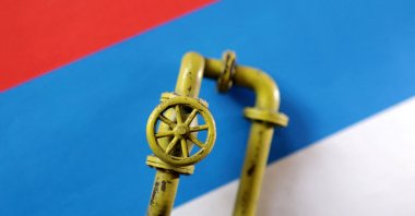 A model of a natural gas pipeline is placed on a Russian flag in this illustration taken on Sept. 7, 2022. (Reuters Photo)