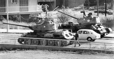 Two Cyprus National Guard tanks wait at a roadblock across the street from the Hilton Hotel as rebel forces consolidated power after the coup, Nicosia (Lefkoşa), Cyprus, July 1974. (AP Photo)