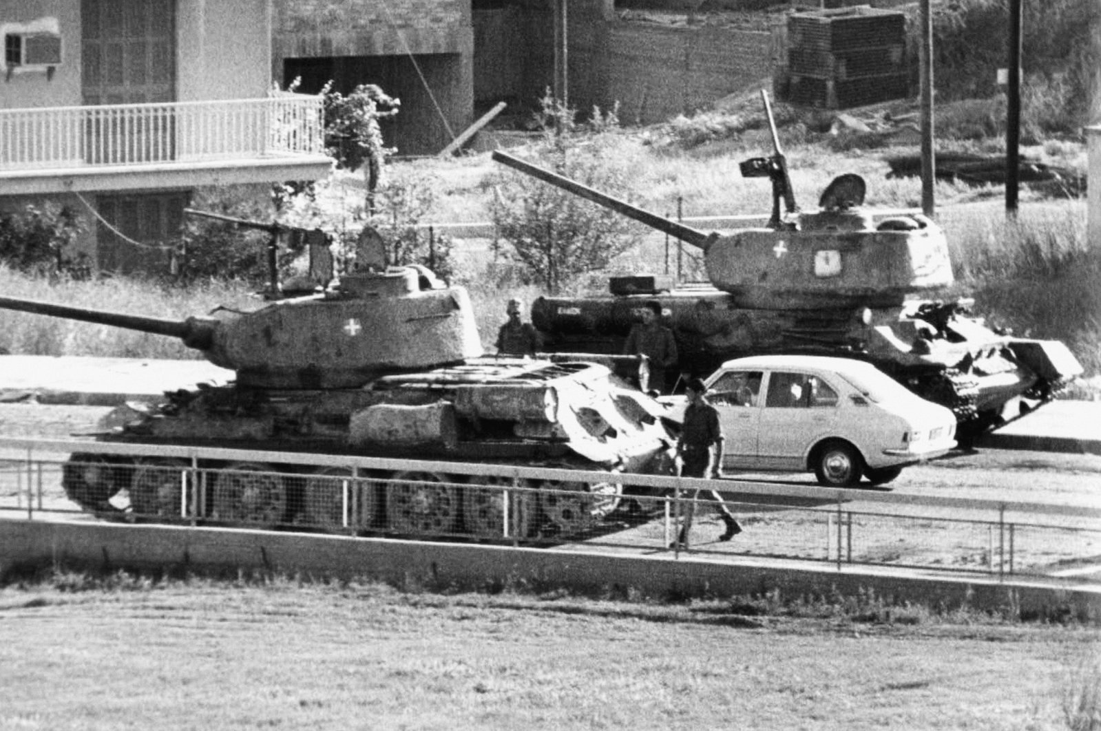 Two Cyprus National Guard tanks wait at a roadblock across the street from the Hilton Hotel as rebel forces consolidated power after the coup, Nicosia (Lefkoşa), Cyprus, July 1974. (AP Photo)