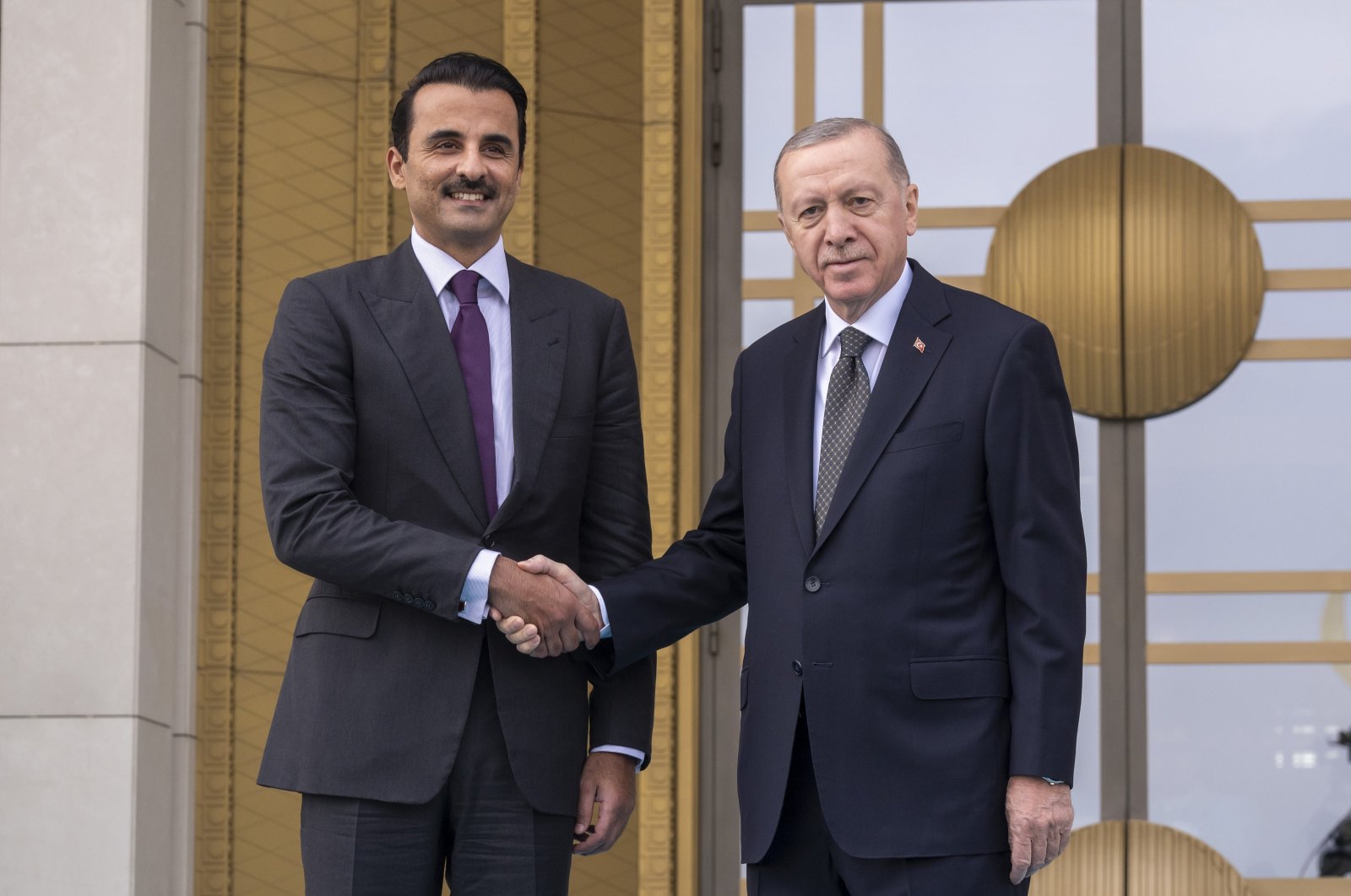 Qatari Emir Sheikh Tamim bin Hamad Al Thani (L) shakes hands with President Recep Tayyip Erdoğan as he arrives in Ankara, Türkiye, Nov. 14, 2024. (AA Photo)