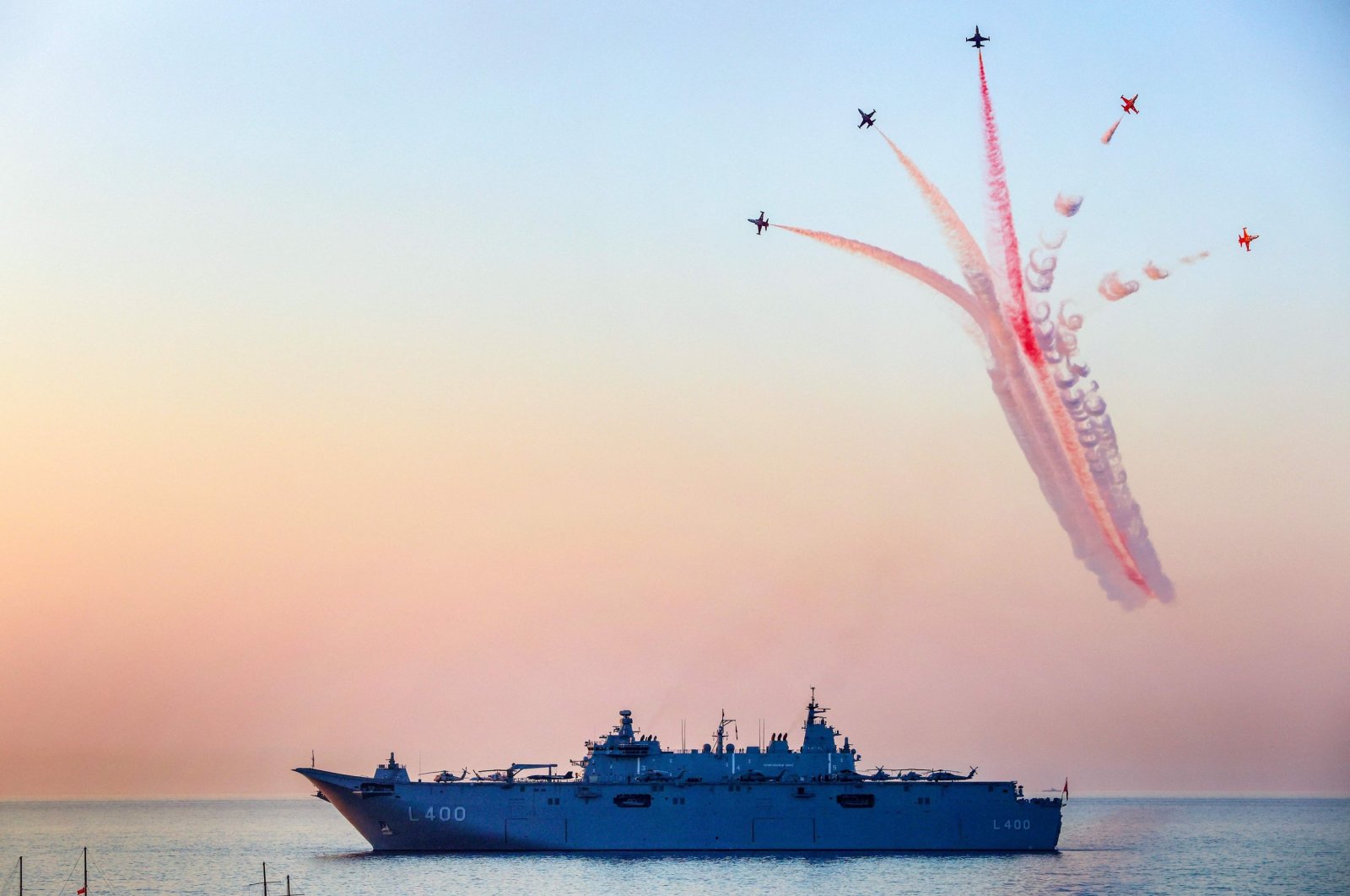 Turkish fighter jets fly over a battleship during a ceremony to mark 50 years of Türkiye&#039;s Cyprus Peace Operation in the city of Girne (Kyrenia), TRNC, July 20, 2024. (AFP Photo)