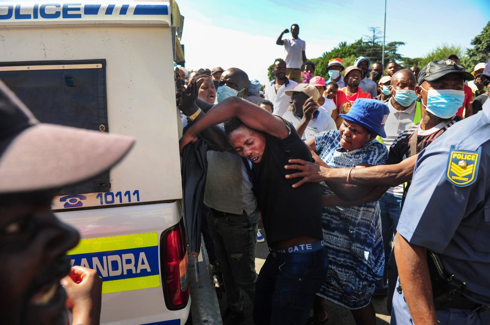 Police officers attend the scene as South African citizens, who are members of Operation Dudula, clash with foreign nationals in the Alexandra township, Johannesburg, South Africa, March 30, 2022. (Getty Images Photo)