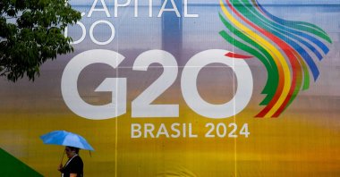 A woman walks past a sign for the G-20 summit, Rio de Janeiro, Brazil, Nov. 16, 2024. (AFP Photo)