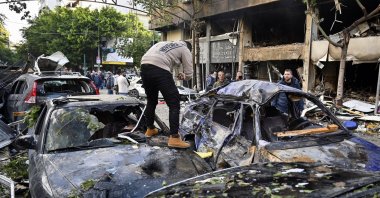 A man inspects his damaged car following an Israeli airstrike in Mar Elias Street, Beirut, Lebanon, Nov. 18, 2024. (EPA Photo)